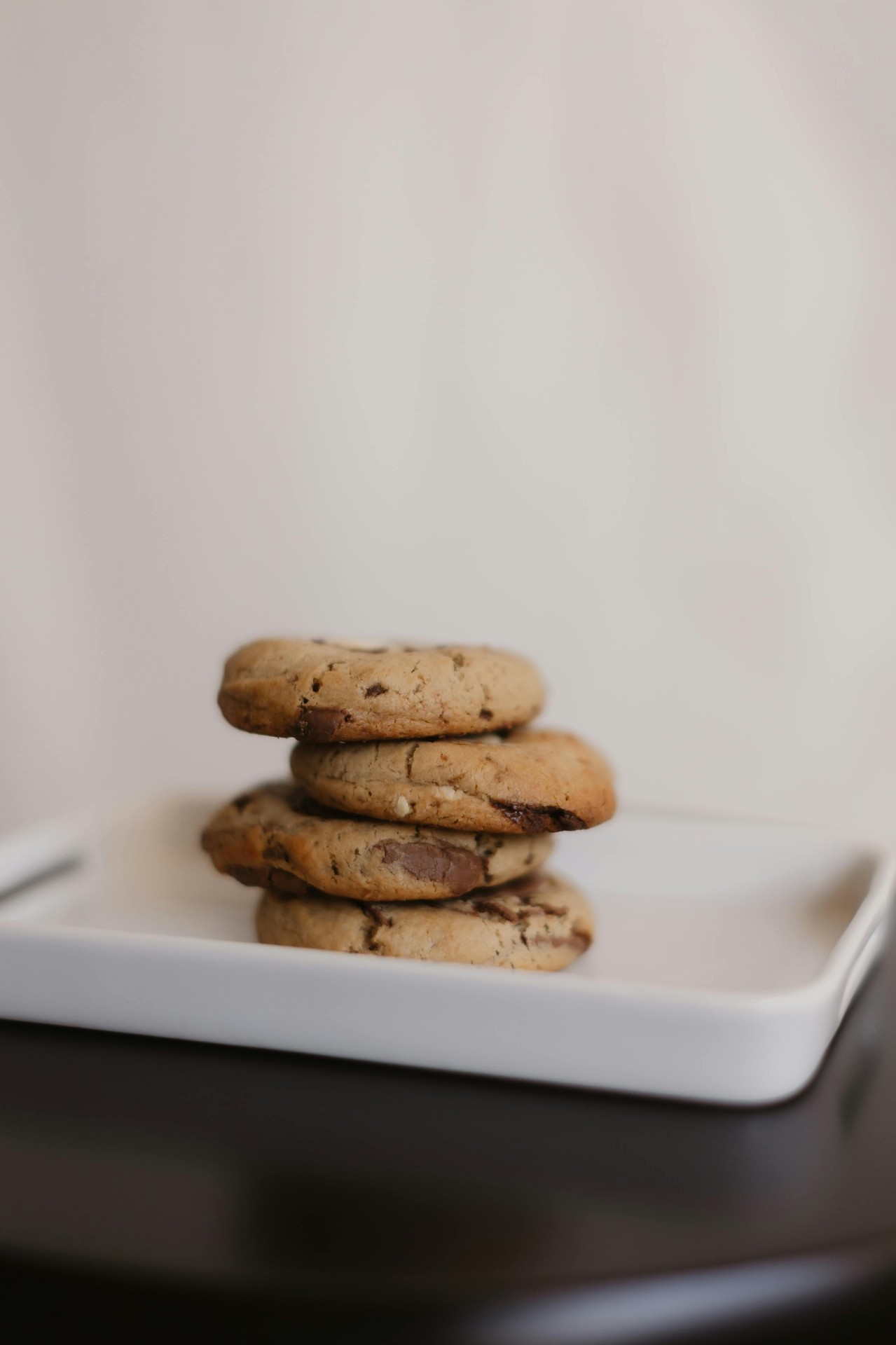 Stack of golden gluten-free bone broth cookies on a white plate, made with The Osso organic bone broth stick rich in collagen
